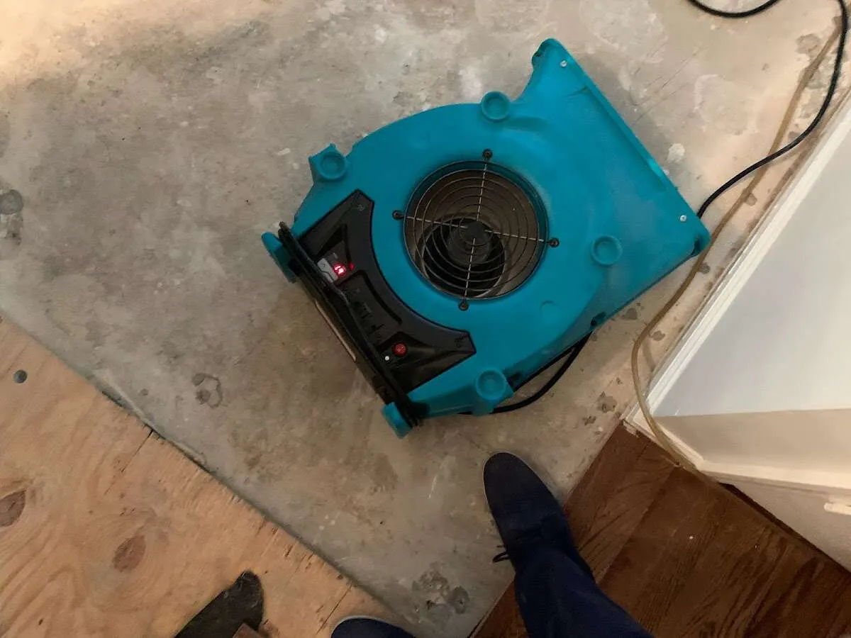 Air mover drying subfloor during Commercial Water Damage Restoration in Marshfield